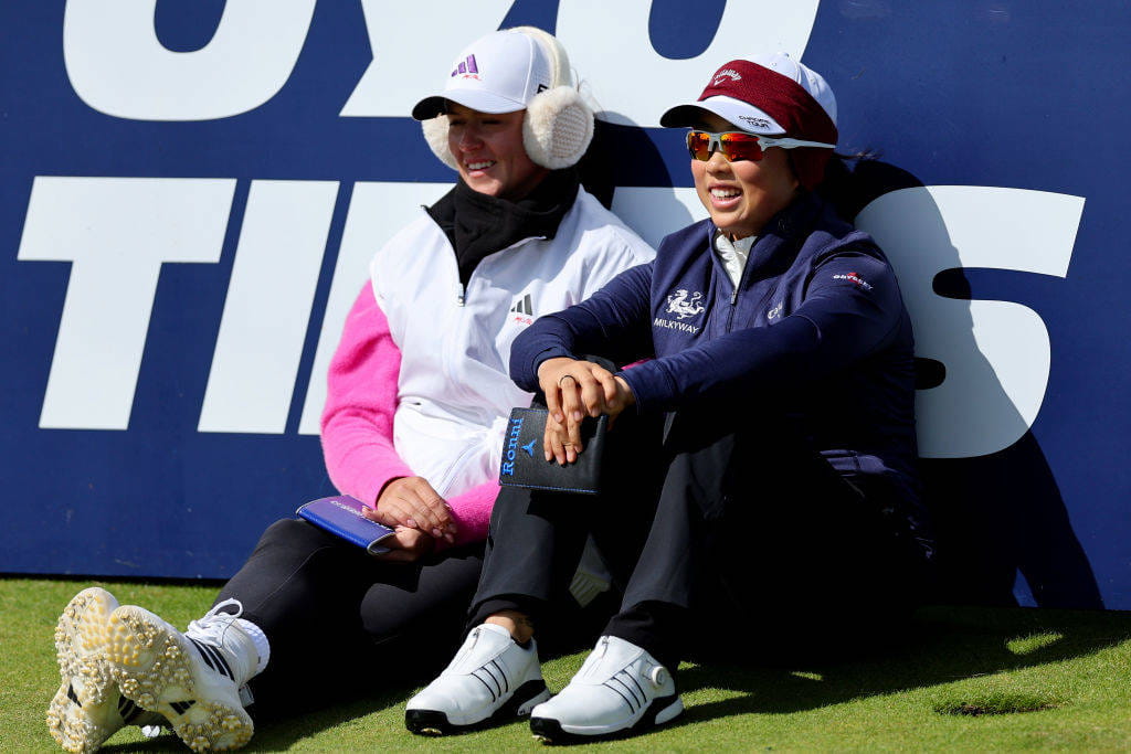 Ruoning Yin and Linn Grant smile as they sit on the 8th tee